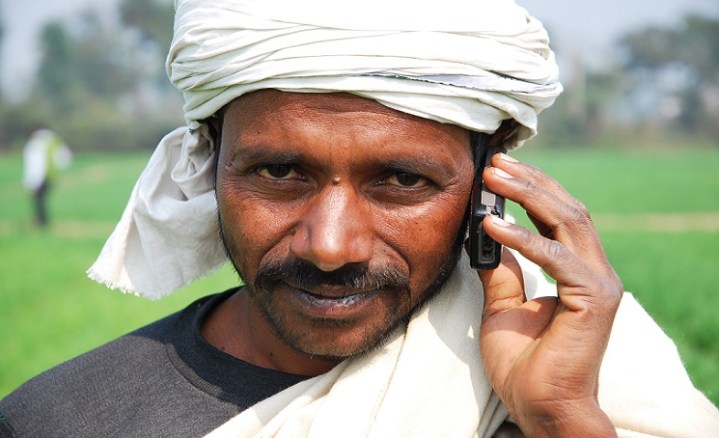 Farmer with his mobile phone in Bihar, India